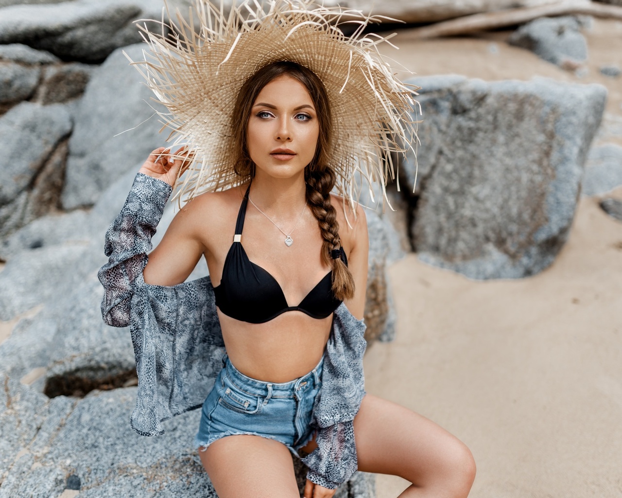 women, hat, bikini top, rocks, necklace, women outdoors, sand, sitting, brunette, belly, jean shorts