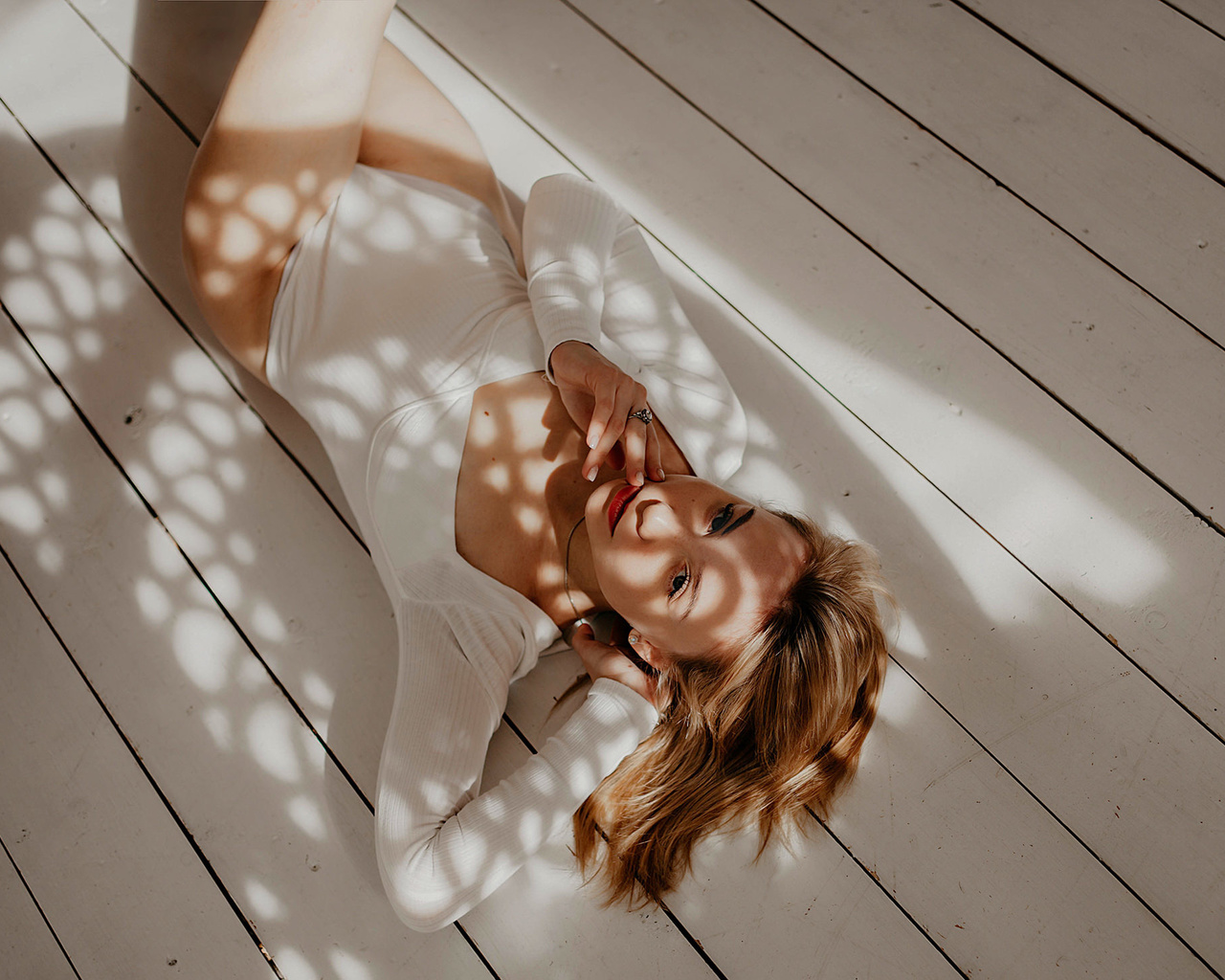 women, blonde, lying on back, top view, wooden floor, bodysuit, red lipstick, women indoors, on the floor, shadow