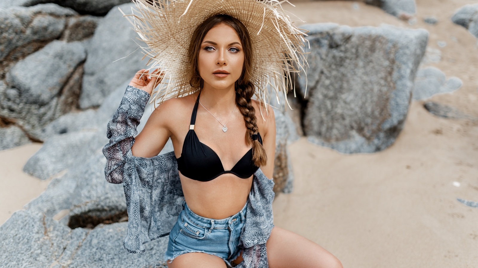 women, hat, bikini top, rocks, necklace, women outdoors, sand, sitting, brunette, belly, jean shorts