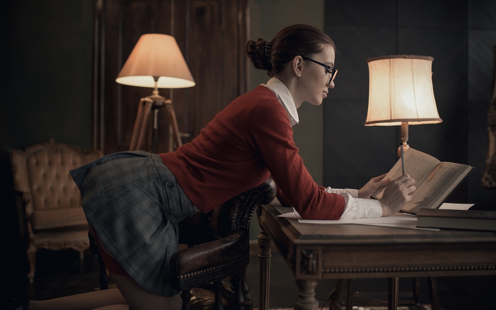 women, lamp, women indoors, skirt, hairbun, chair, garter belt, red sweater, mirror, books, kneeling, women with glasses, reflection