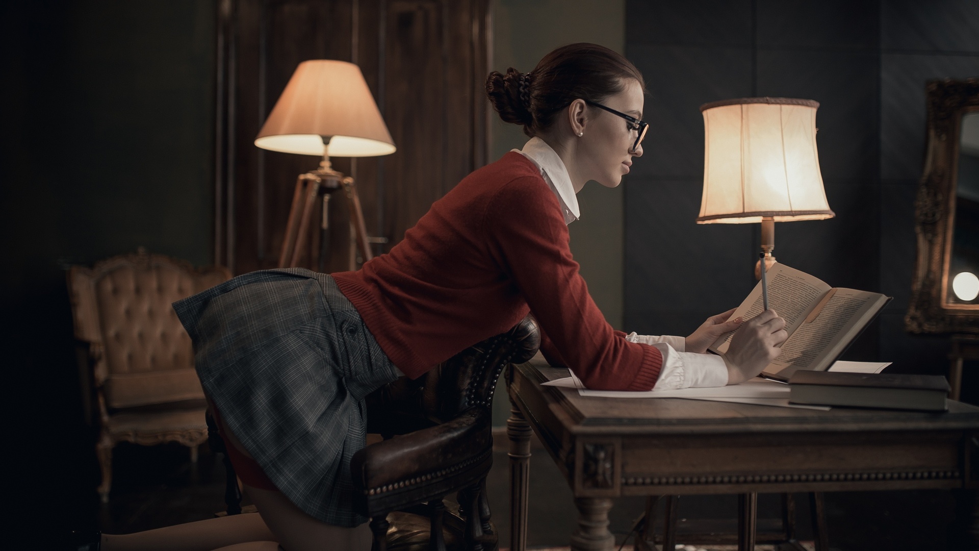 women, lamp, women indoors, skirt, hairbun, chair, garter belt, red sweater, mirror, books, kneeling, women with glasses, reflection