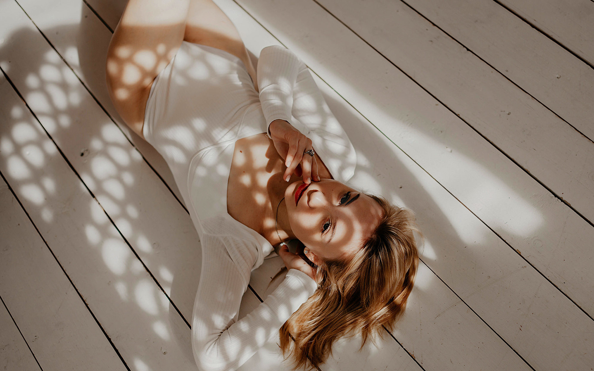 women, blonde, lying on back, top view, wooden floor, bodysuit, red lipstick, women indoors, on the floor, shadow