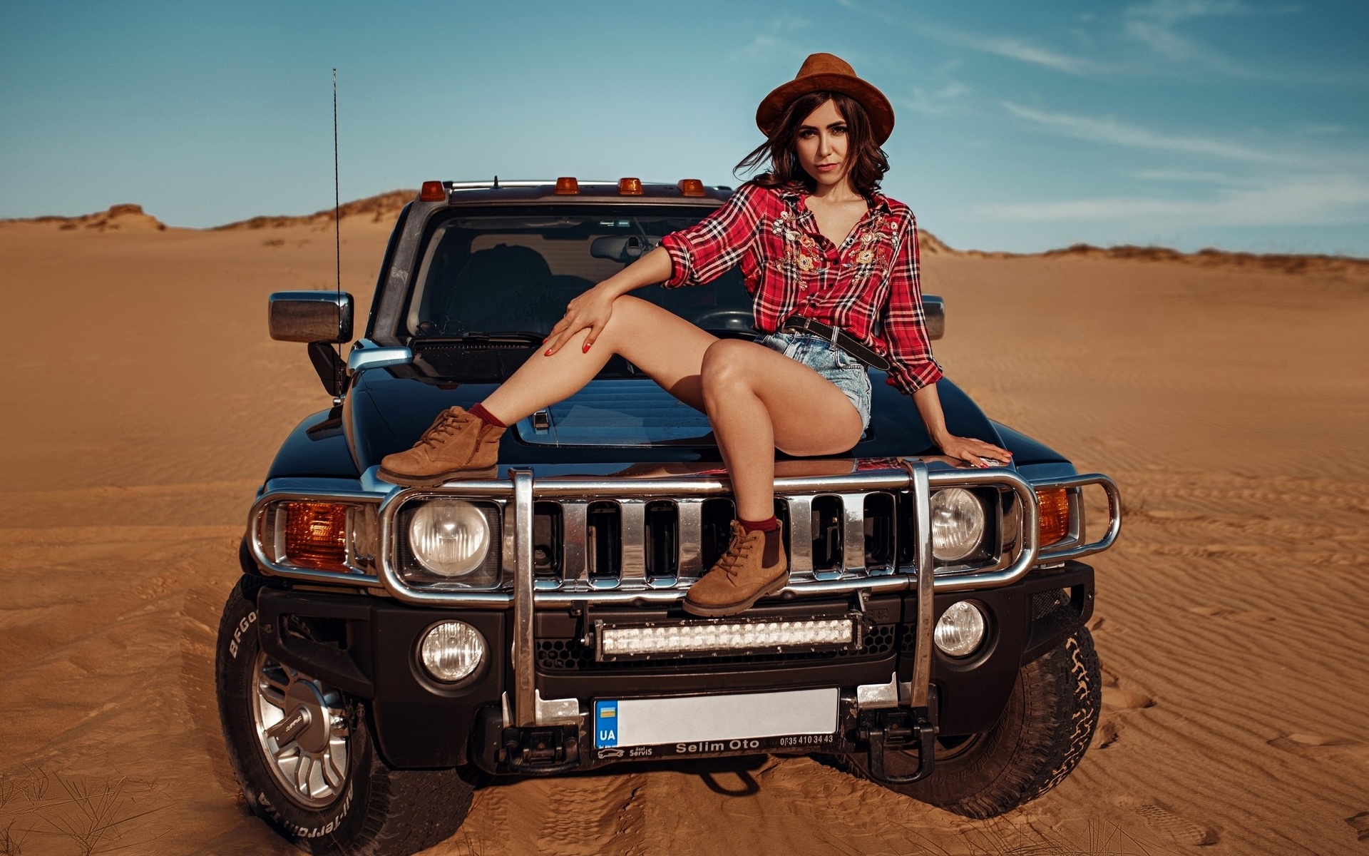 women, hat, women outdoors, sky, clouds, car, desert, plaid shirt, jean shorts, women with cars, shoes, red nails, socks, belt, sitting