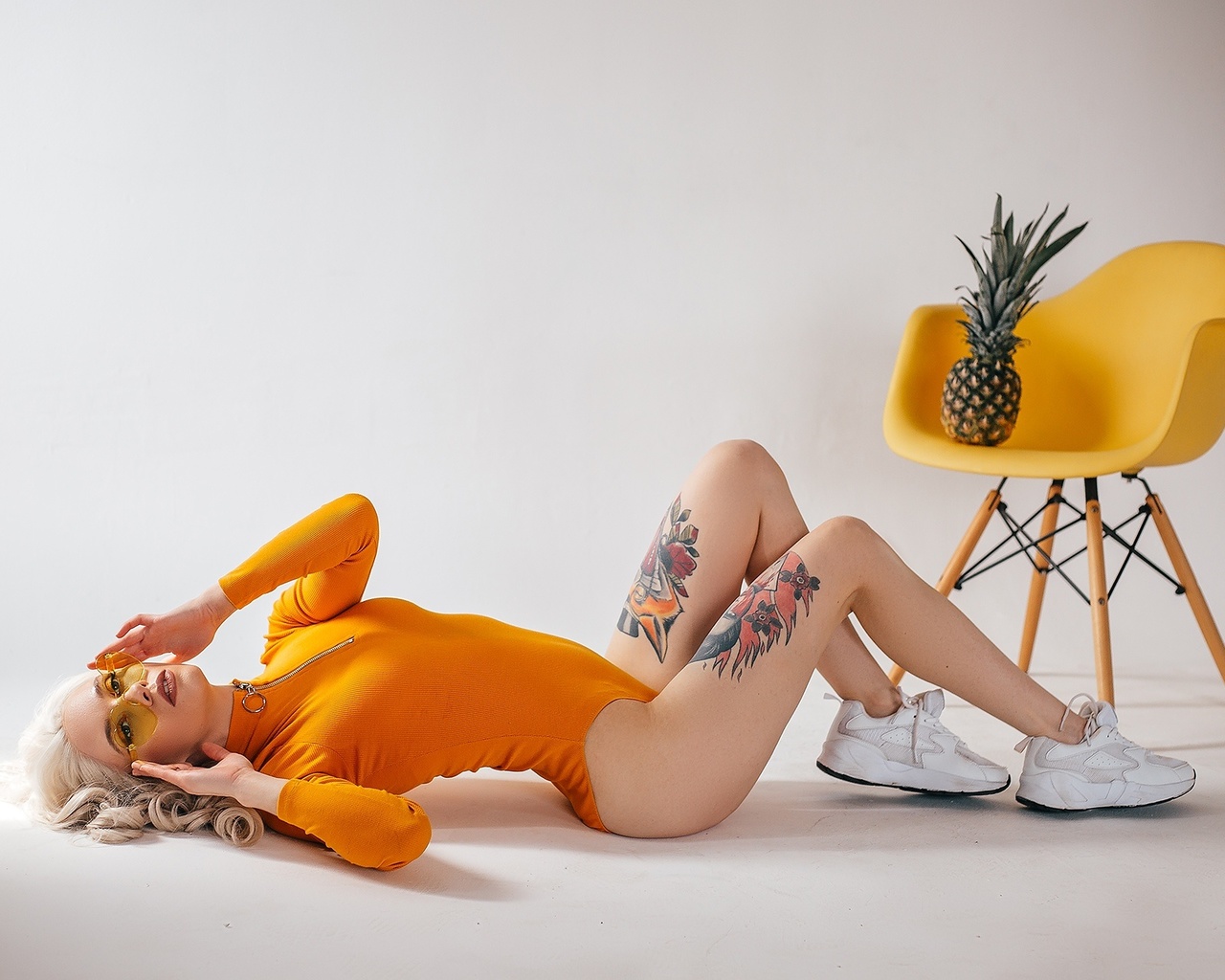 women, studio, sneakers, blonde, chair, pineapple, tattoo, glasses, bodysuit, leotard, on the floor