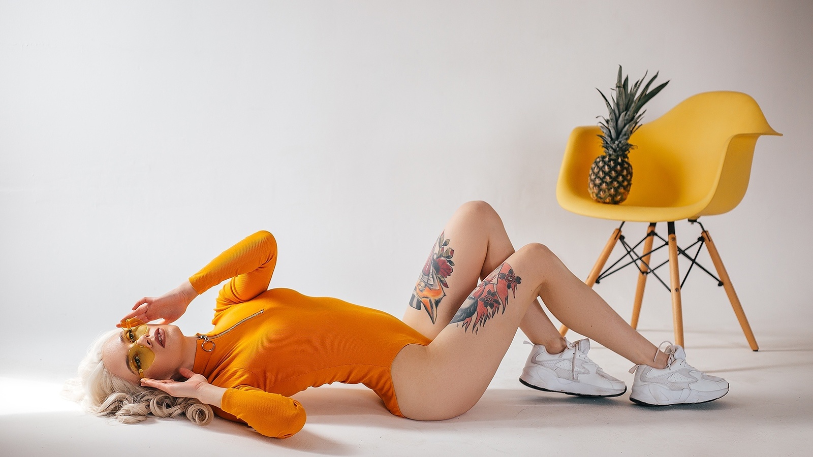 women, studio, sneakers, blonde, chair, pineapple, tattoo, glasses, bodysuit, leotard, on the floor