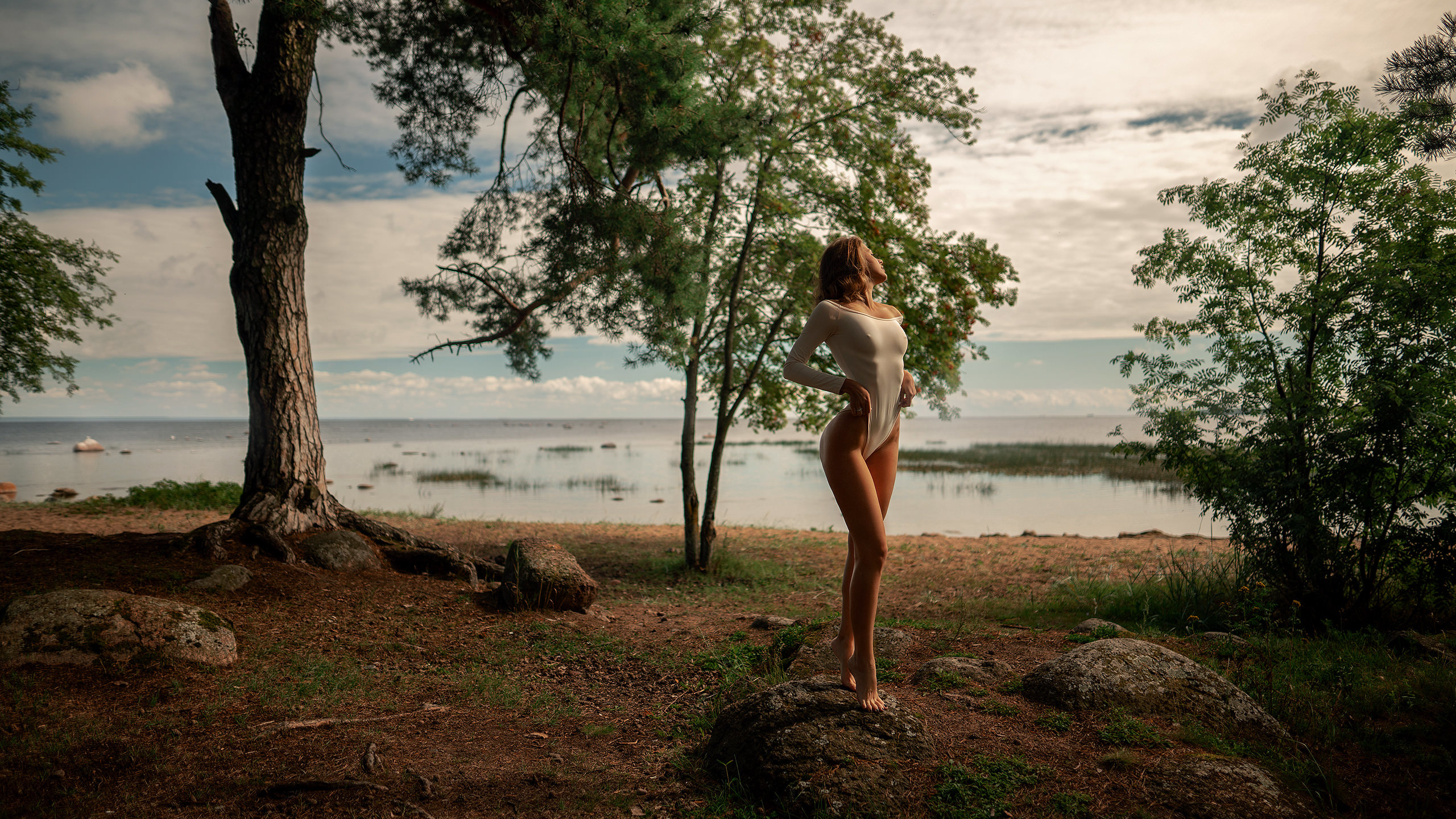 women, bodysuit, trees, water, sky, clouds, women outdoors, nipples through clothing, ribs, rocks, brunette