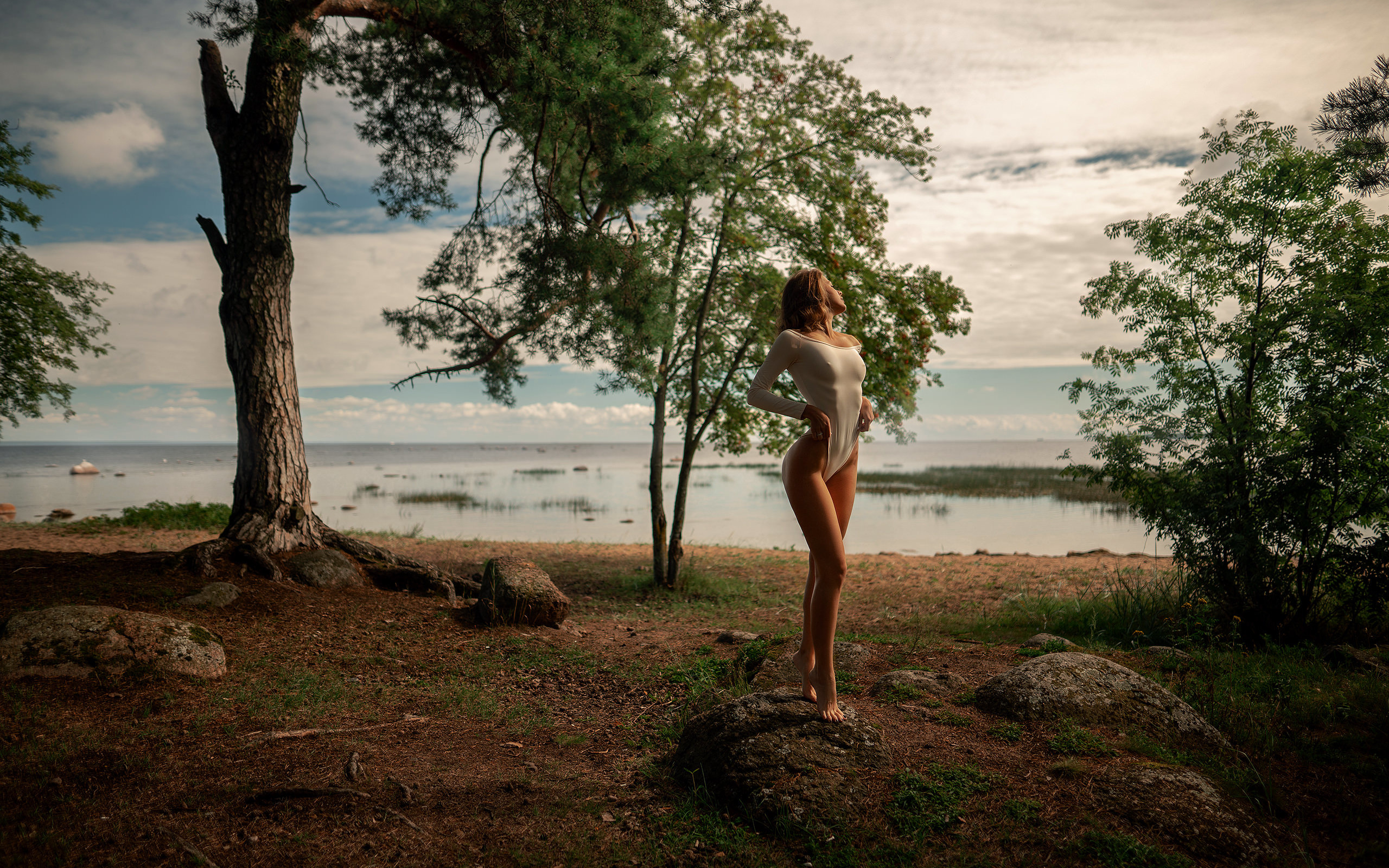 women, bodysuit, trees, water, sky, clouds, women outdoors, nipples through clothing, ribs, rocks, brunette