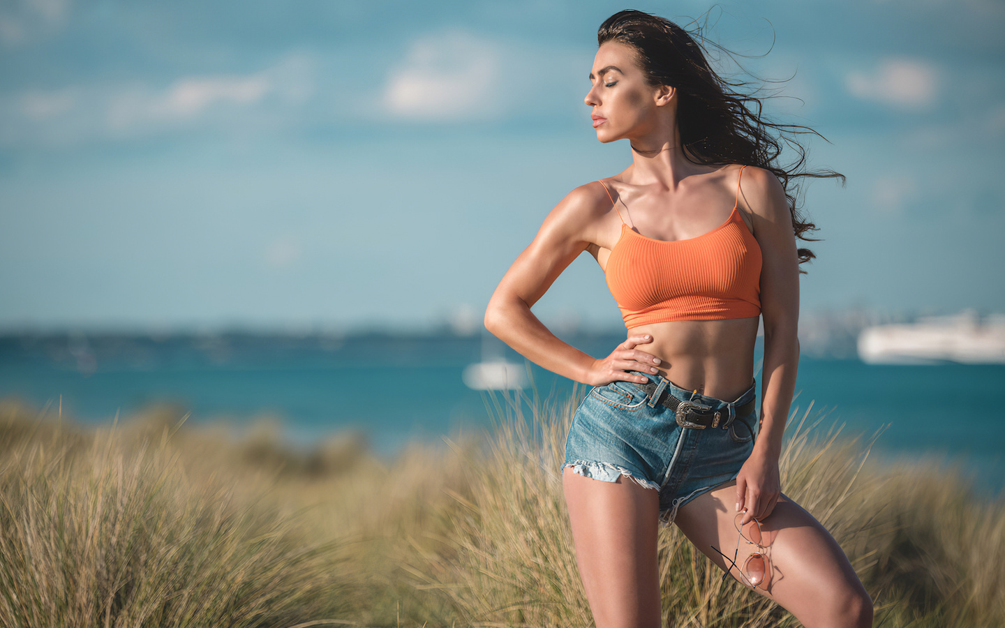 eliza rose watson, beach, sunglasses, denim shorts, sea, grass, brunette, brunette girl, wind, air, beautiful girl, boobs, belly,sky