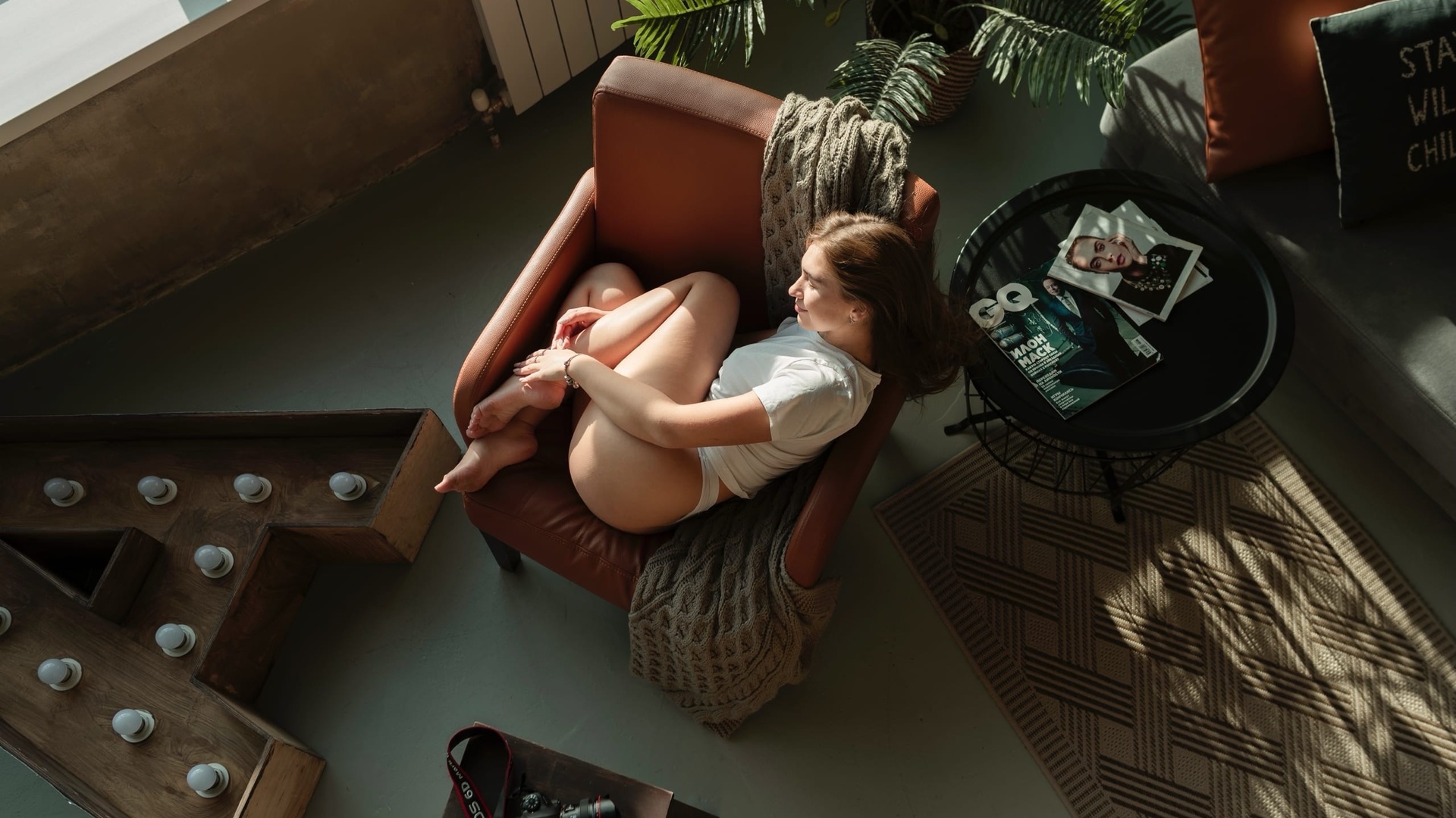 women, white t-shirt, white panties, women indoors, top view, window, light bulb, ass, brunette, armchair, camera, magazine, plants, couch