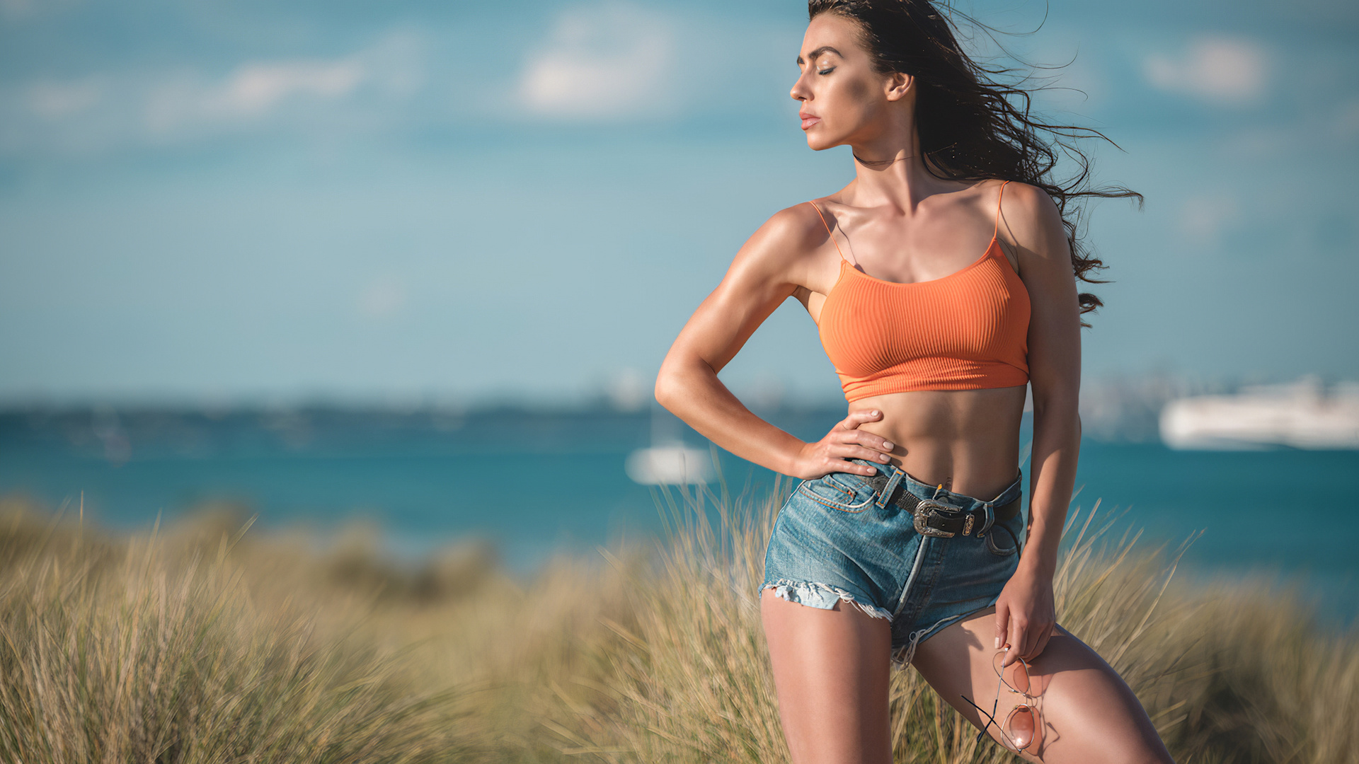 eliza rose watson, beach, sunglasses, denim shorts, sea, grass, brunette, brunette girl, wind, air, beautiful girl, boobs, belly,sky