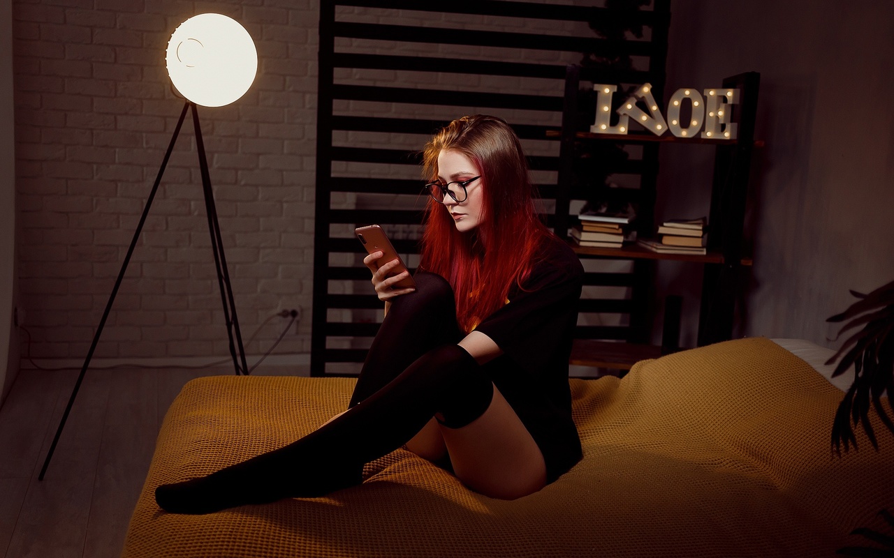 women, dyed hair, batman logo, in bed, black stockings, panties, sitting, glasses, wall, books, black t-shirt, cellphone, women with glasses