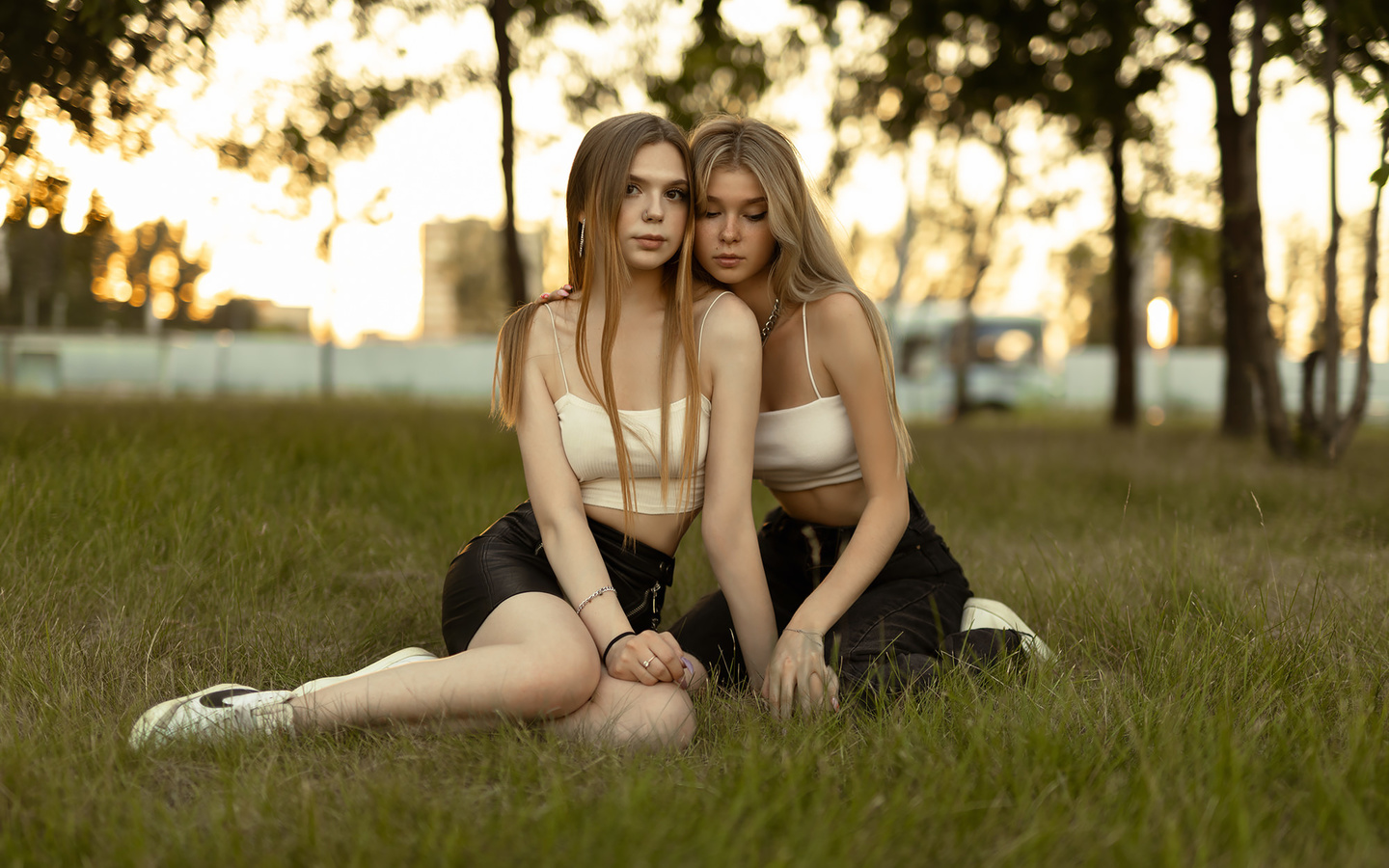 women, sitting, blonde, grass, sneakers, long hair, nike, trees, jeans, two women, nose ring, zipper, skirt