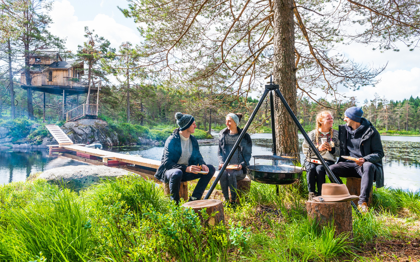 southern norway, summer, friends eating around a bonfire, treetop cabin, lyngdal