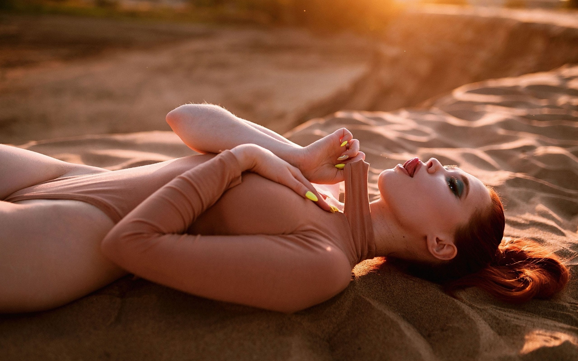 redhead, women, model, women outdoors, bodysuit, hips, tongue out, hips, sunset, closed eyes, sand