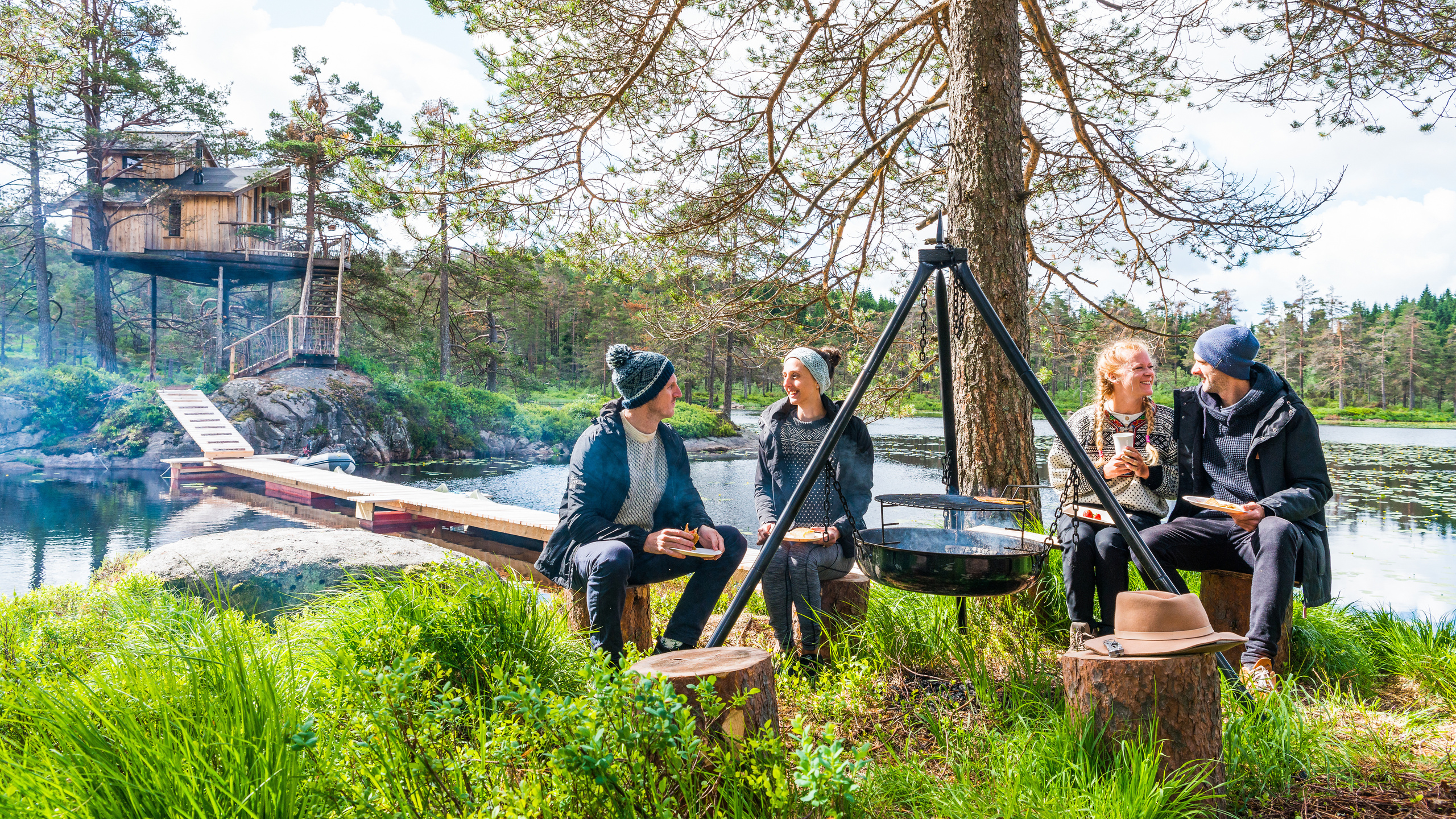 southern norway, summer, friends eating around a bonfire, treetop cabin, lyngdal