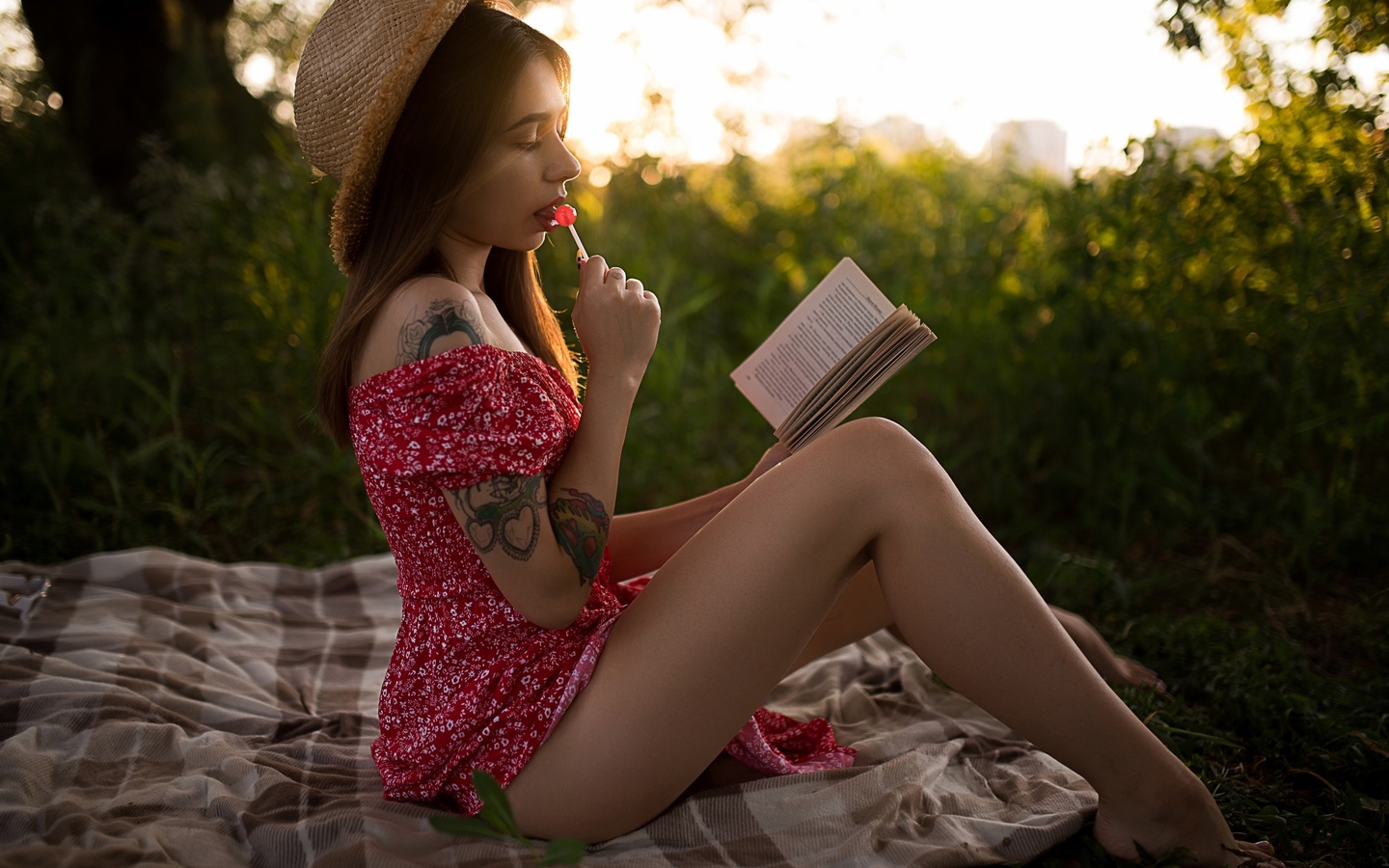 brunette, model, women, women outdoors, summer dress, tattoo, ass, picnic, straw hat, dress, barefoot, book, trees, grass, sunset, sitting, lollipop