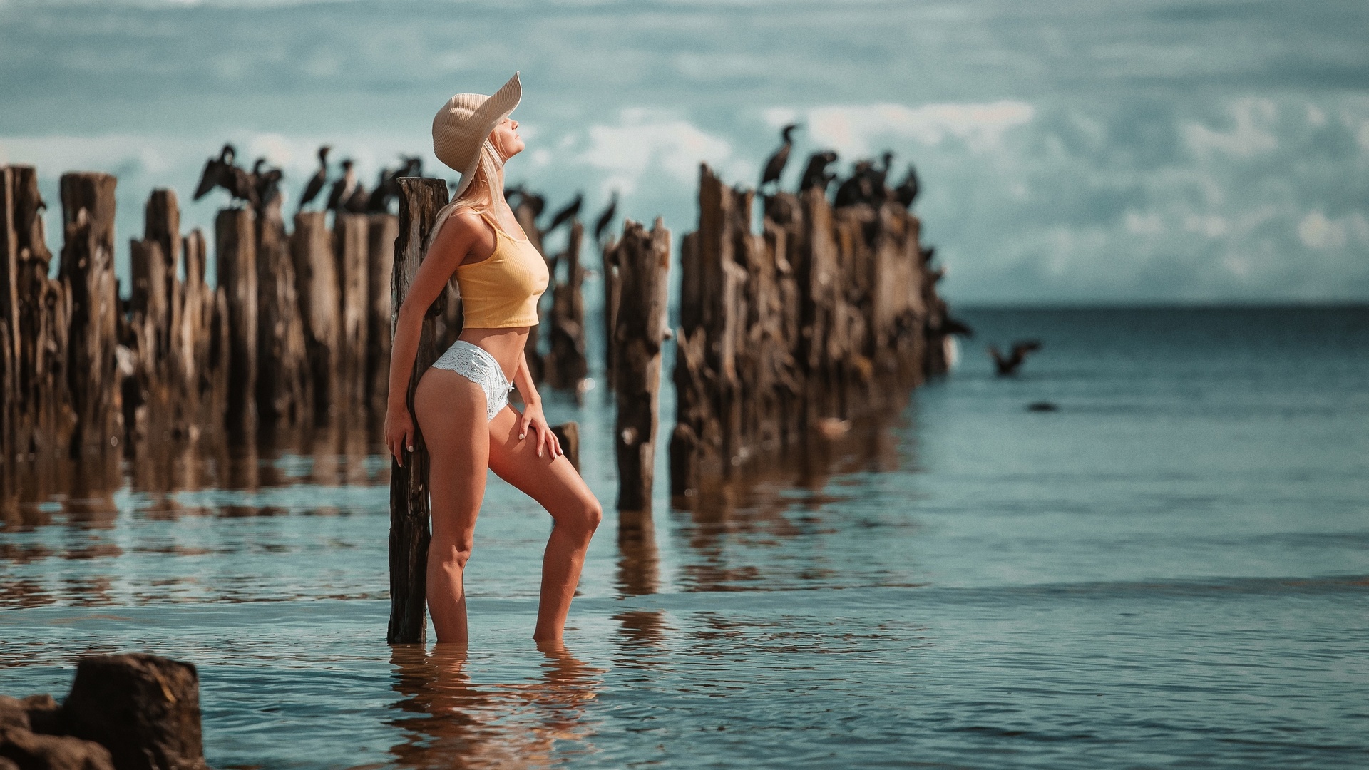 women, blonde, model, women outdoors, beach, sea, white panties, sky clouds, baseball cap, cap, short tops, t-shirt