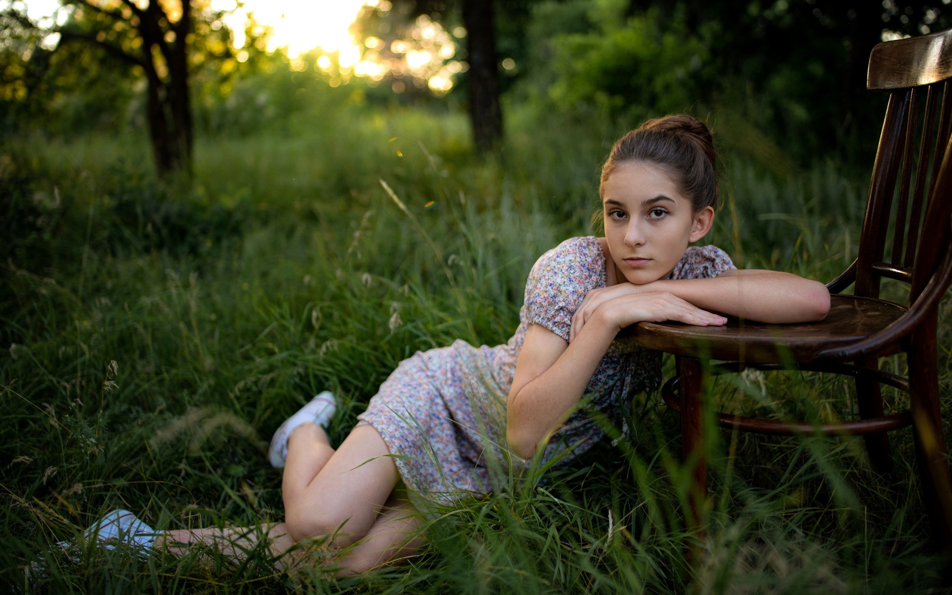 model, brunette, women, women outdoors, grass, trees, nature, dress, summer dress, flowered dress, chair, converse, sneakers