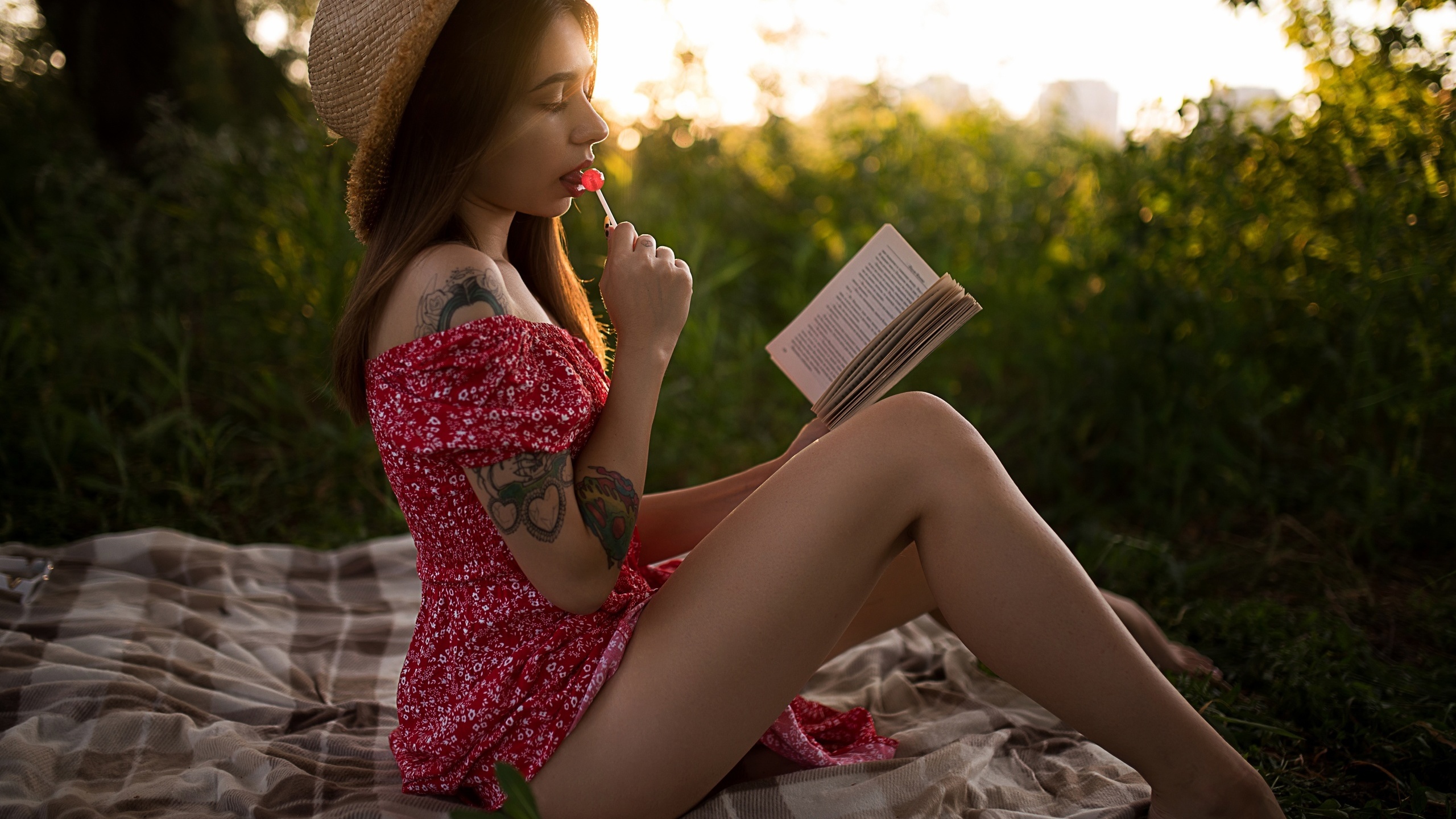 brunette, model, women, women outdoors, summer dress, tattoo, ass, picnic, straw hat, dress, barefoot, book, trees, grass, sunset, sitting, lollipop