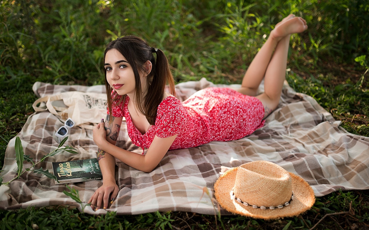 brunette, model, women, women outdoors, summer dress, tattoo, picnic, straw hat, sunglasses, glasses, lying on front, dress, barefoot, pierced ear, books, trees, grass, twintails