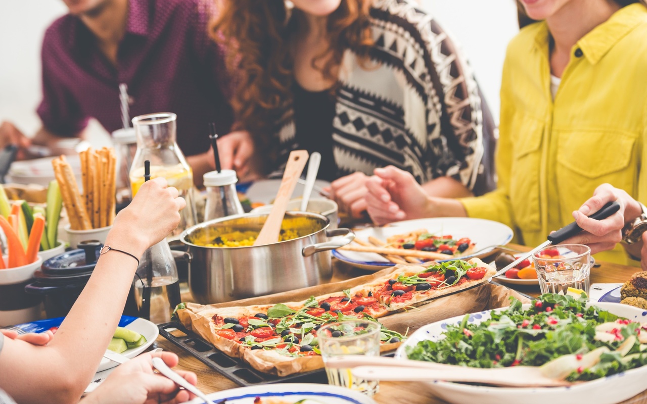 dinner party, communal table, colorful sumptuous dishes, vegetarian eating