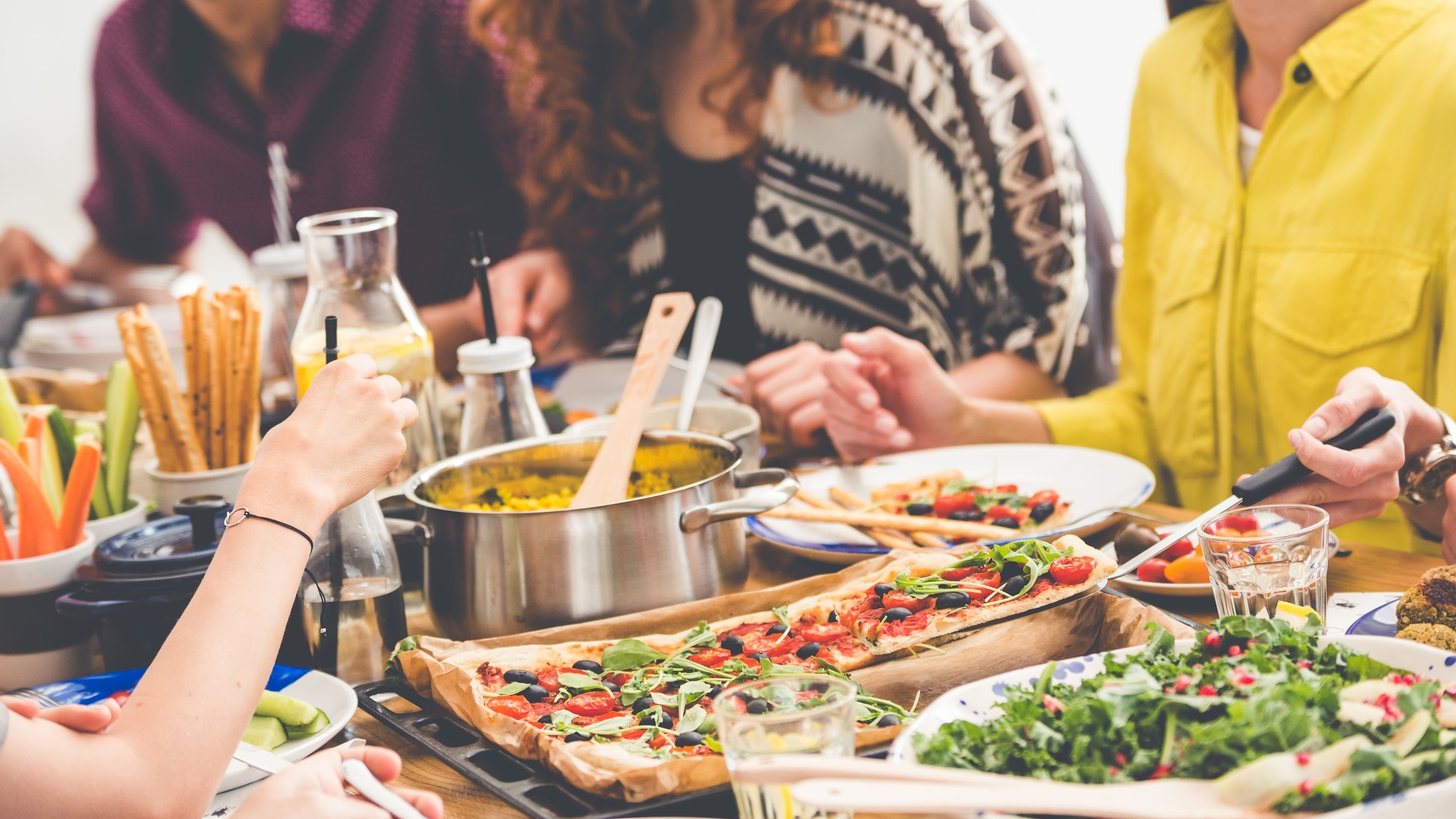 dinner party, communal table, colorful sumptuous dishes, vegetarian eating