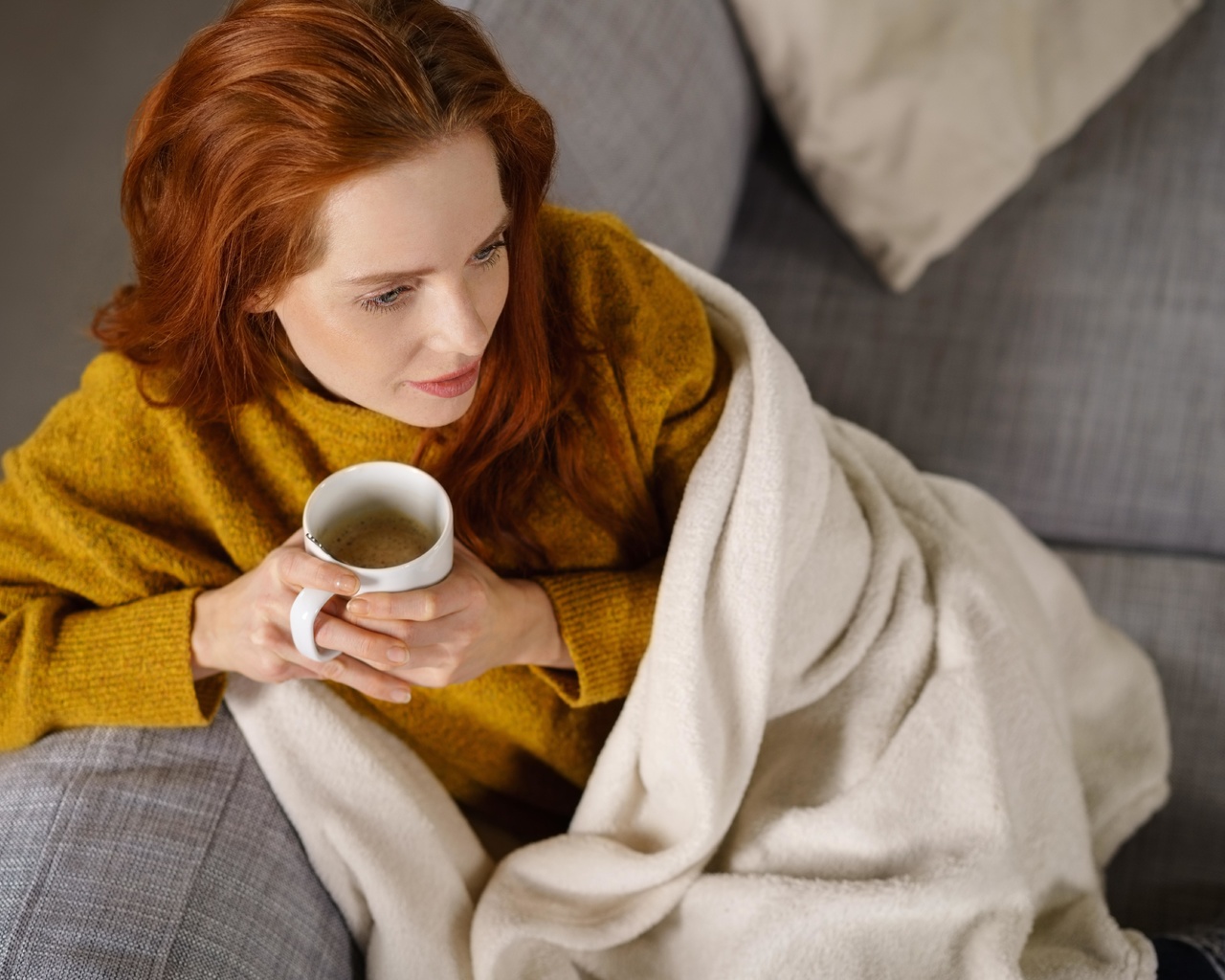 woman, comfortable couch, blanket, coffee