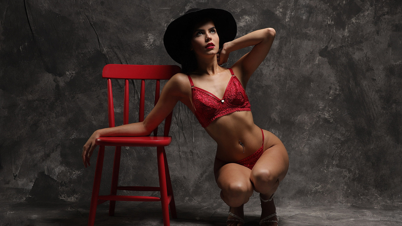 brunette, women, model, studio, women indoors, red panties, red bra, red lingerie, squatting, hips, lingerie, curvy, red chair, chair, black hat, pierced navel