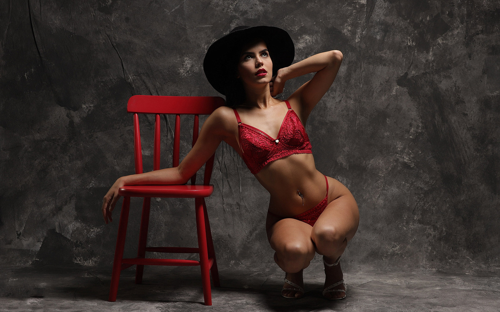 brunette, women, model, studio, women indoors, red panties, red bra, red lingerie, squatting, hips, lingerie, curvy, red chair, chair, black hat, pierced navel