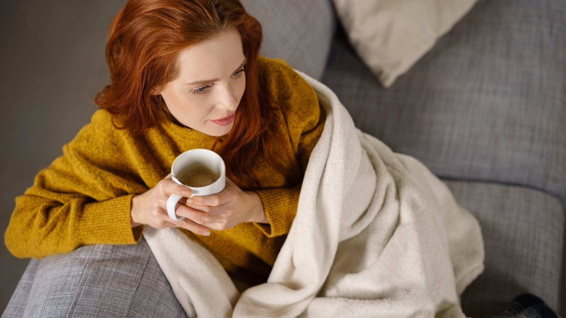 woman, comfortable couch, blanket, coffee