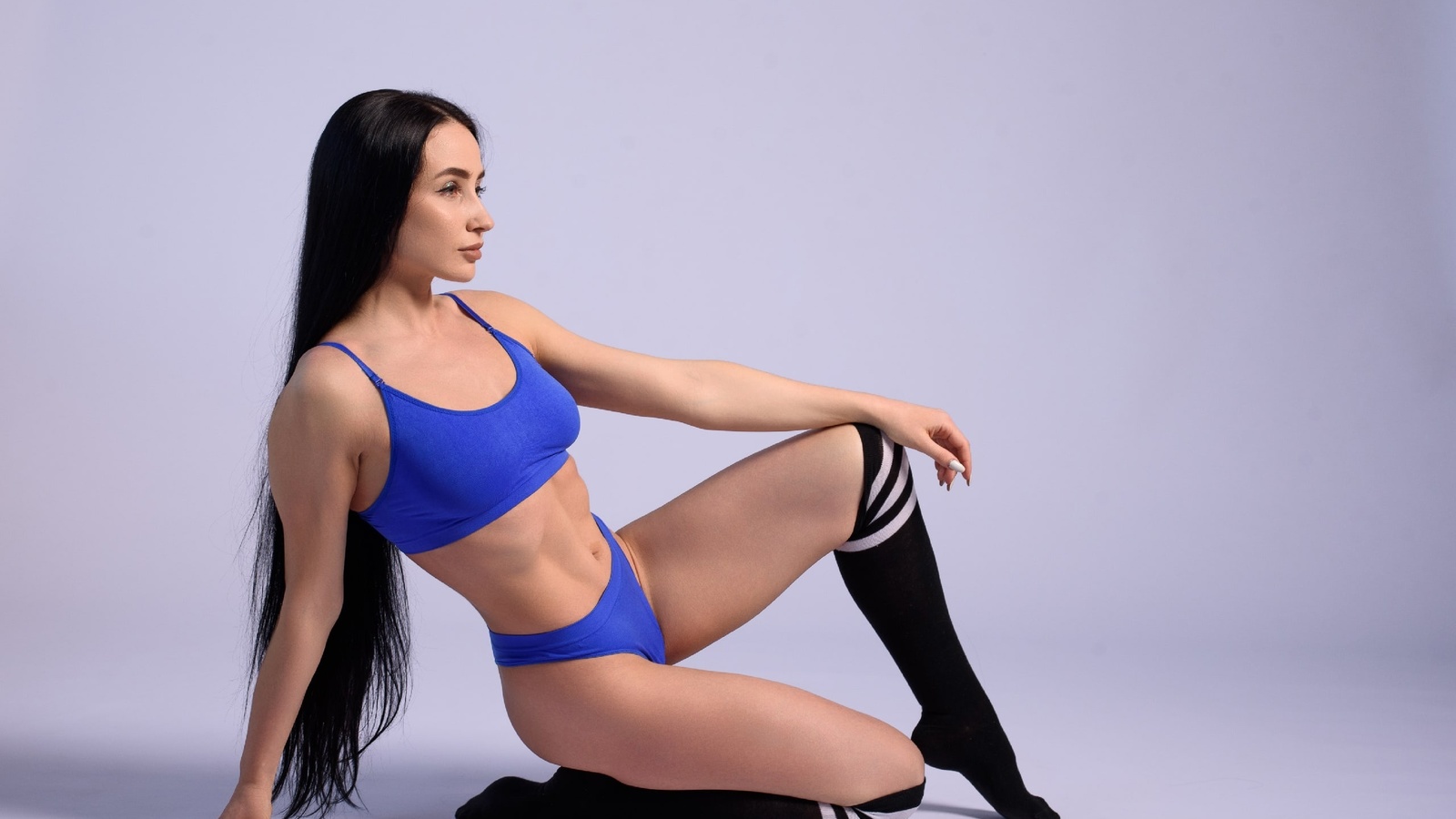 brunette, model, women, studio, blue tops, sports bra, fitness model, blue panties, women indoors, white background, simple background, ass, hips, long hair, black socks, striped socks