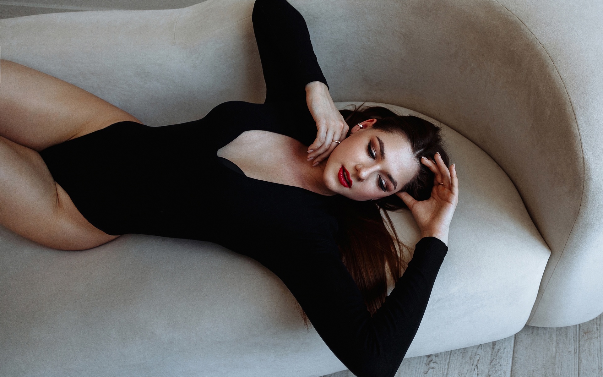 model, women, brunette, hips, couch, women indoors, black bodysuit, bodysuit, wooden floor