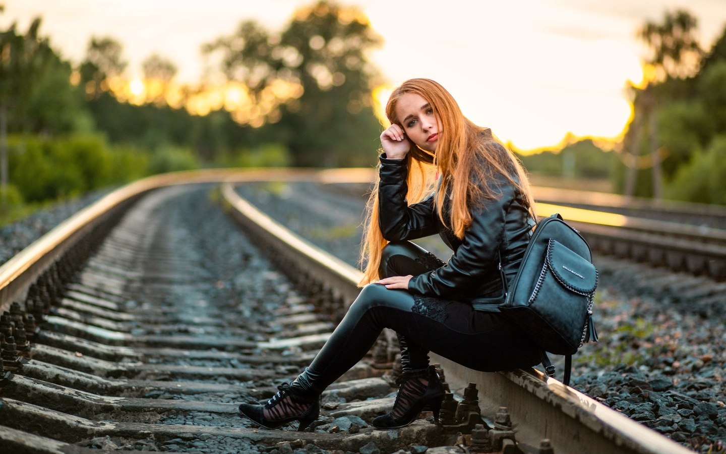 , railway, women, women outdoors, leather clothing, leather pants, leather jacket, trees, sky, backpack, redhead, nature, model, sitting, long hair