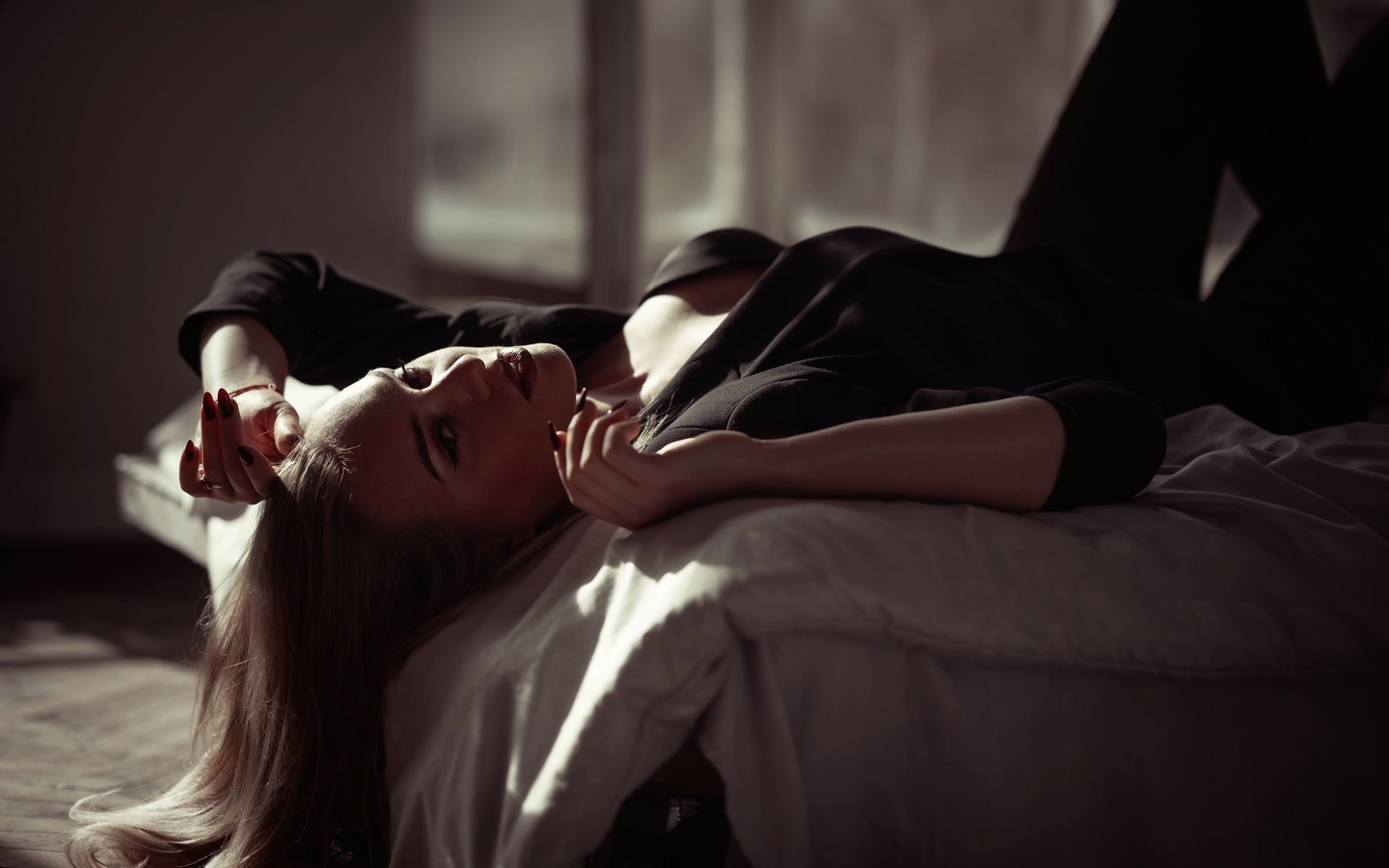 women indoors, in bed, blonde, , black pants, model, lying on back, jacket, black clothing, black jacket, red lipstick, makeup