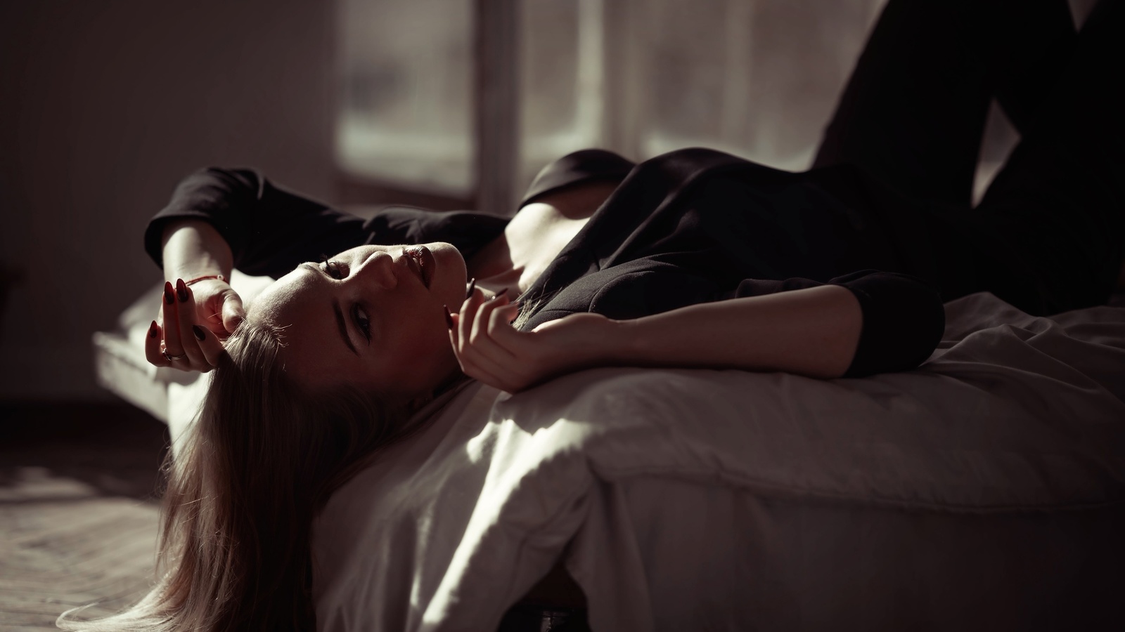 women indoors, in bed, blonde, , black pants, model, lying on back, jacket, black clothing, black jacket, red lipstick, makeup