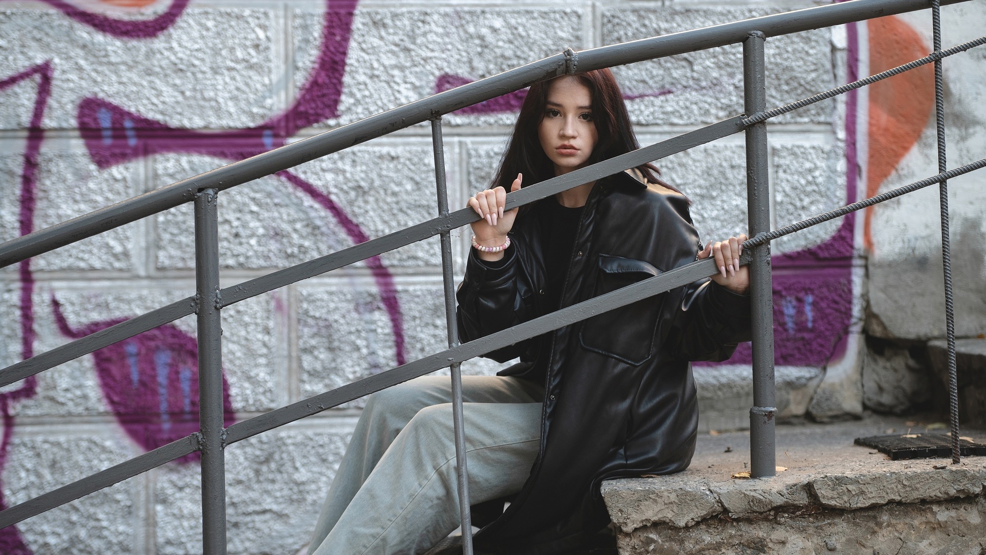 jeans, public, brunette, sitting, urban, , women outdoors, model, railing, trench coat, black jacket, graffiti, wall