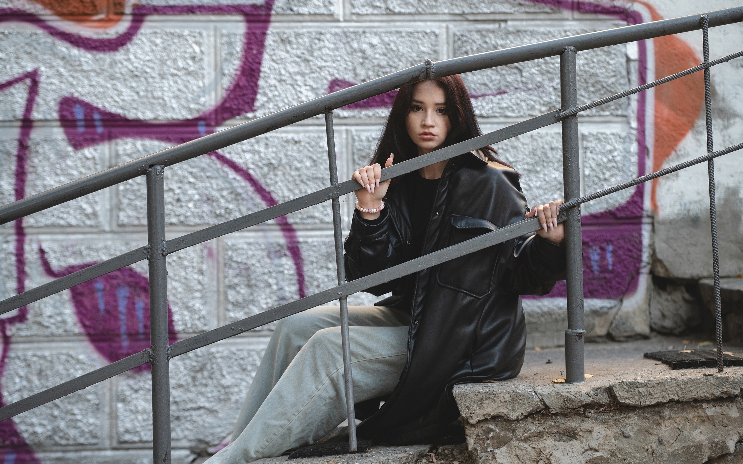 jeans, public, brunette, sitting, urban, , women outdoors, model, railing, trench coat, black jacket, graffiti, wall