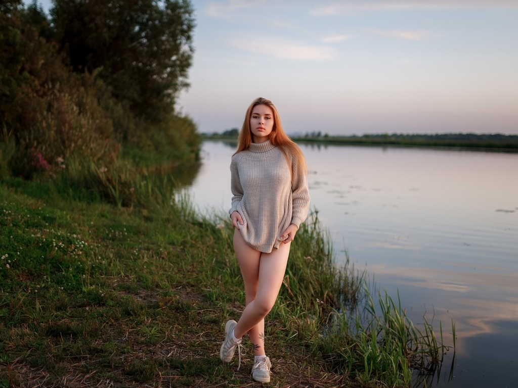 women outdoors, , lake, redhead, sky, legs, nature, model, grass, trees, clouds, tattoo, , women, sneakers, water, reflection, sweater, arms crossed