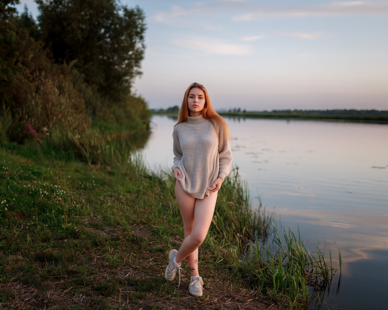 women outdoors, , lake, redhead, sky, legs, nature, model, grass, trees, clouds, tattoo, , women, sneakers, water, reflection, sweater, arms crossed