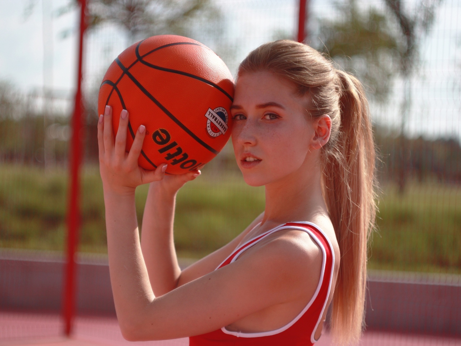 basketball, blonde, looking at viewer, , ponytail, model, women outdoors, sky, freckles, ball, sport, long hair