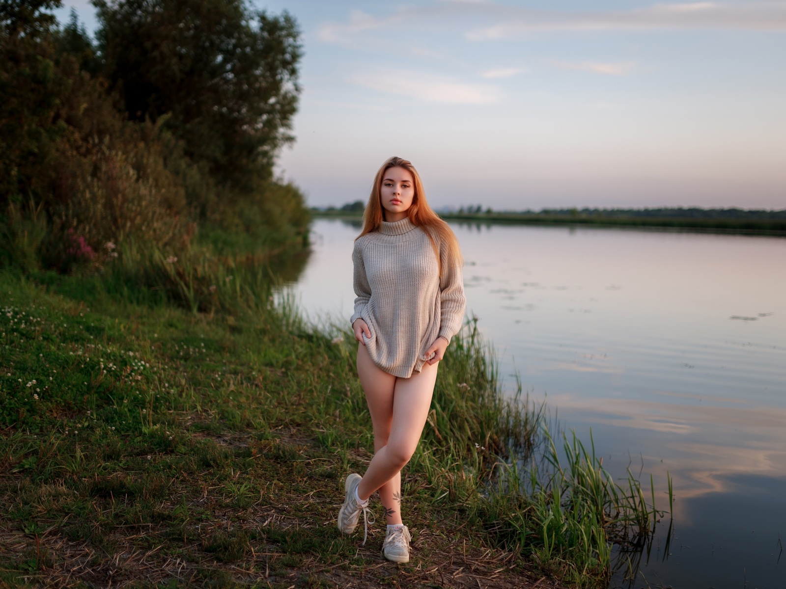 women outdoors, , lake, redhead, sky, legs, nature, model, grass, trees, clouds, tattoo, , women, sneakers, water, reflection, sweater, arms crossed