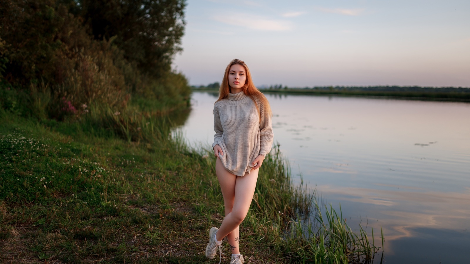 women outdoors, , lake, redhead, sky, legs, nature, model, grass, trees, clouds, tattoo, , women, sneakers, water, reflection, sweater, arms crossed