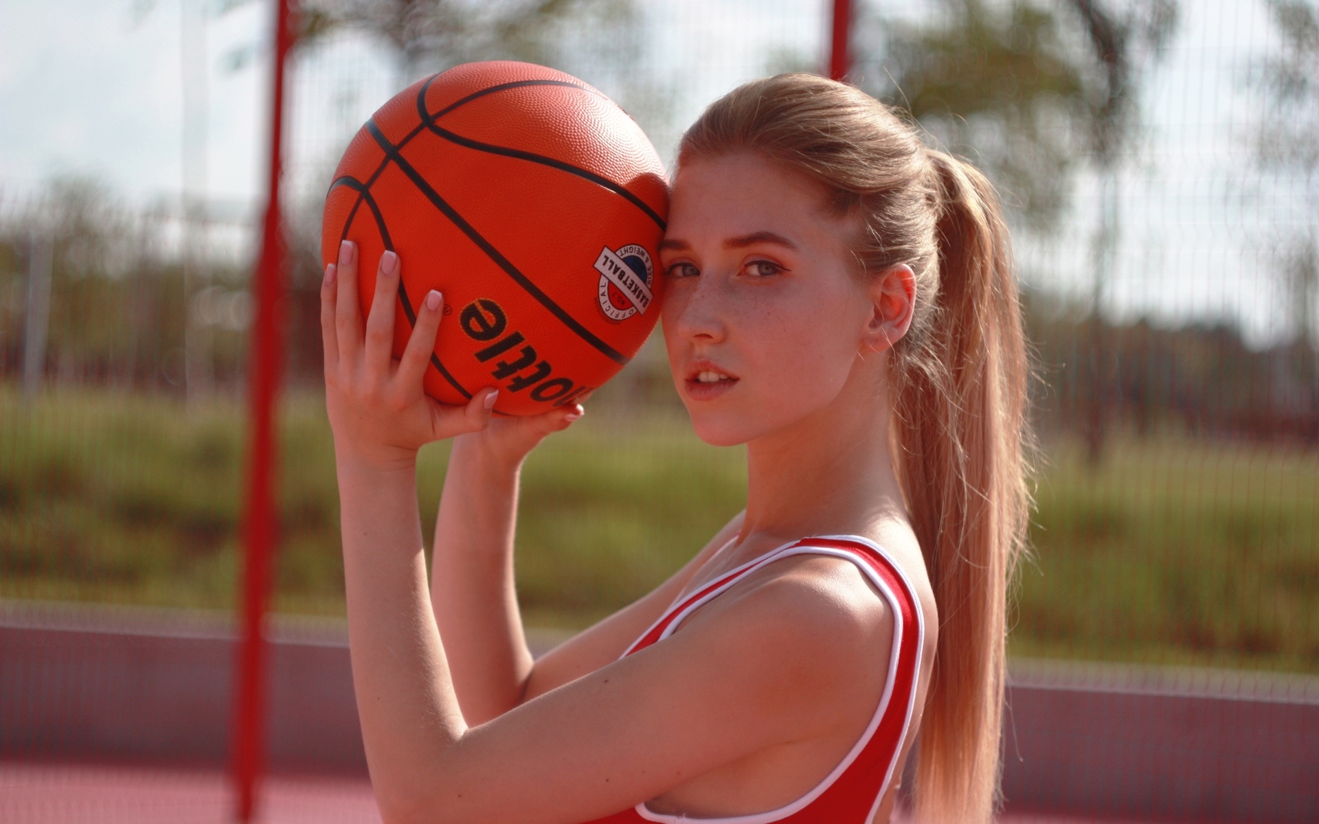 basketball, blonde, looking at viewer, , ponytail, model, women outdoors, sky, freckles, ball, sport, long hair