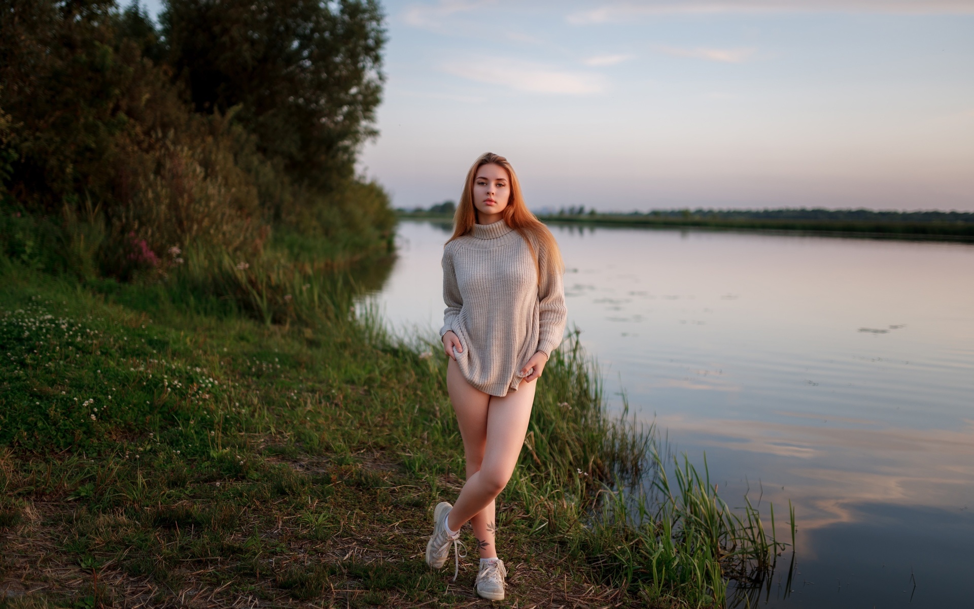 women outdoors, , lake, redhead, sky, legs, nature, model, grass, trees, clouds, tattoo, , women, sneakers, water, reflection, sweater, arms crossed