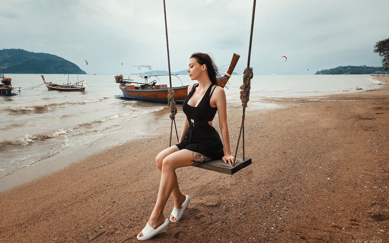 yaguar photography, sitting, swings, , model, women on beach, sky, brunette, tattoo, boat, women outdoors, clouds, minidress, black dress, women, flip flops, beach