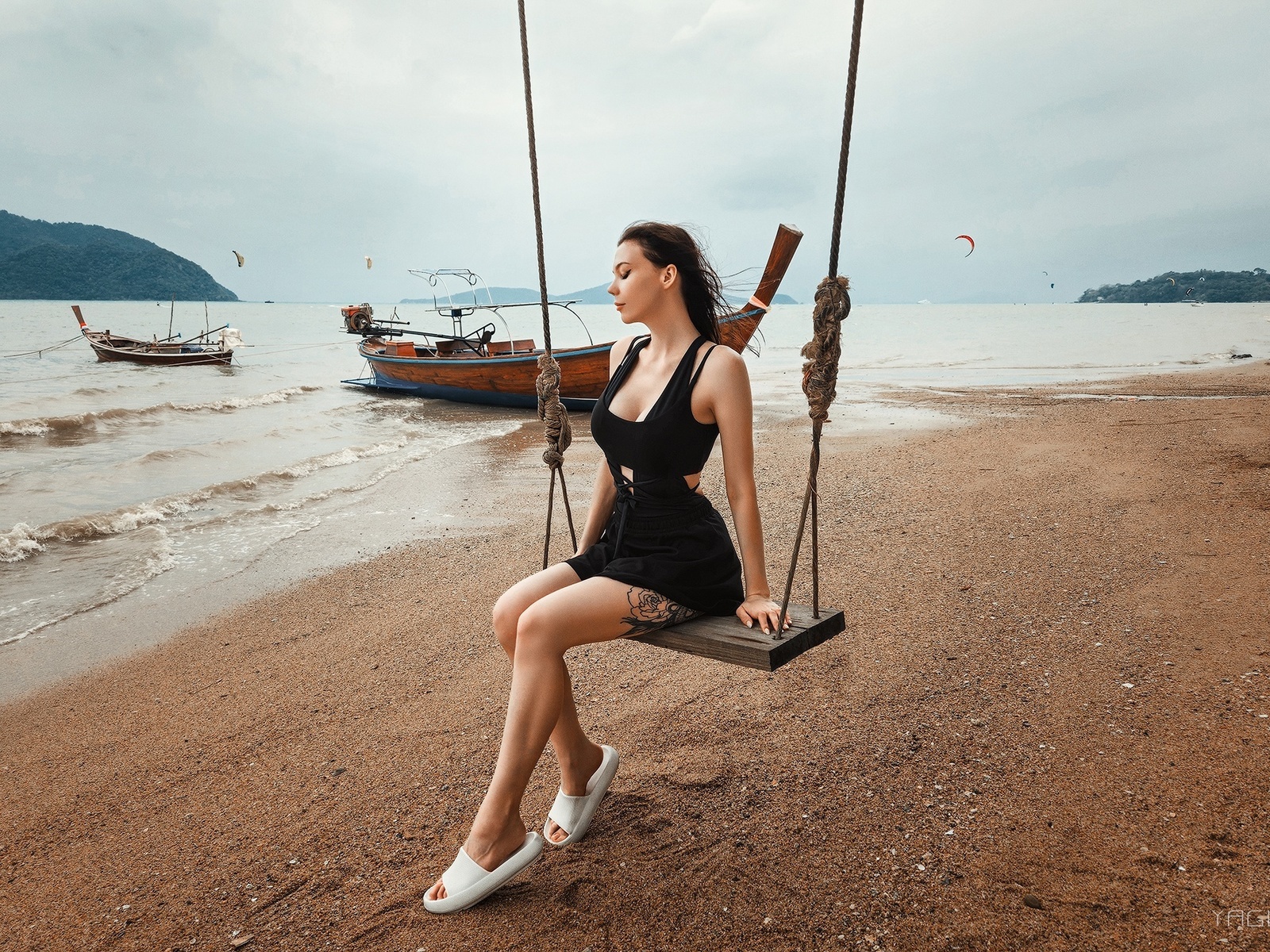 yaguar photography, sitting, swings, , model, women on beach, sky, brunette, tattoo, boat, women outdoors, clouds, minidress, black dress, women, flip flops, beach